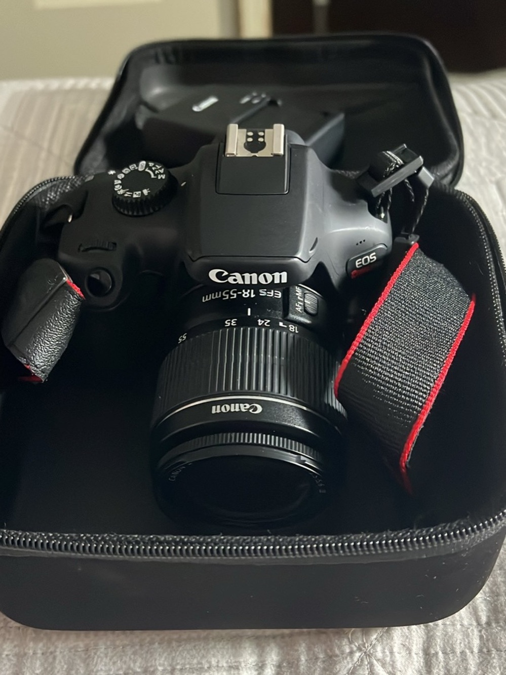 Canon Black DSLR with 18-55mm Lens and Red-Trim Strap